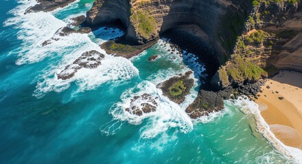 Stunning coastal scene shows turquoise ocean waves crashing against rocky cliffs and a small sandy beach. Dramatic rock formations create natural caves and arches along the shoreline.
