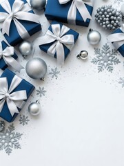 Fototapeta premium Beautiful blue and silver gifts, sparkling baubles, and snowflakes arranged on a white background, symbolizing celebration and joy for the festive holiday season