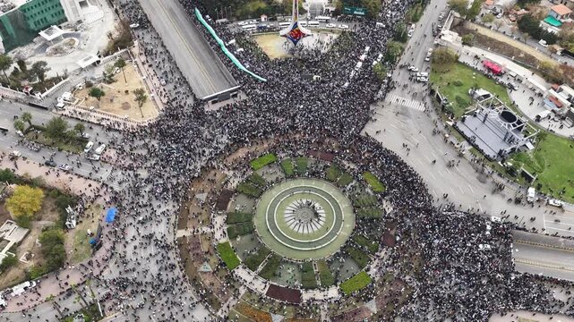 A drone shot of the famous Umayyad Square in central Damascus, Syria, where thousands of people gathered carrying Syrian flags.