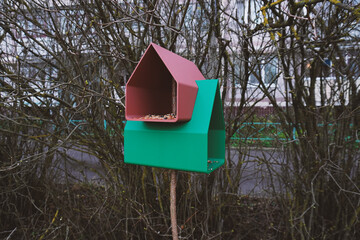 Free plastic bird feeder in the garden printed on a 3d printer. Feeding birds in winter. Bird watching. Eco-friendly backyard habitat.