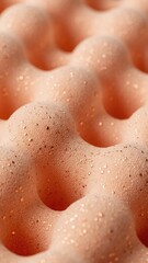 Fototapeta premium Macro of soft peach foam texture with sparkling golden glitter. Convoluted egg-crate pattern as abstract background