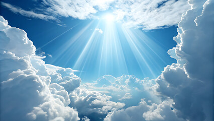 Bright sun rays shining down through dramatic white clouds in a vibrant blue sky, representing hope, heaven, or divine light