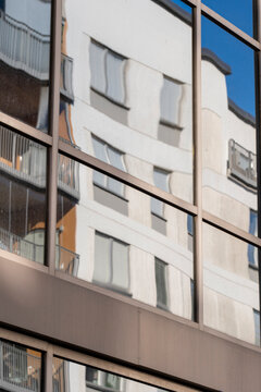 Minimalism and symmetry define this modern geometric architecture facade, where abstract building pattern and reflection form a clean visual structure