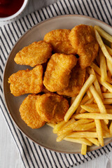 Naklejka premium Chicken Nuggets with French Fries on a Plate, top view.