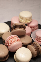 tall macaron tower on slate, vertical portrait framing stacked pastel cookies with delicate fillings and boutique patisserie vibe