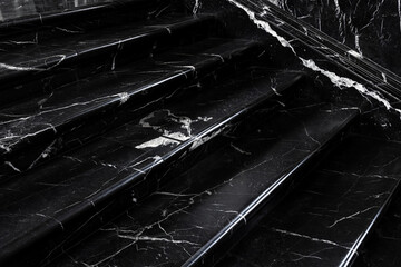 Close up polished black white marble stairs elegant texture bright veins creating dramatic contrast. Reflective surface adds depth subtle light enhances luxurious stone pattern architectural detail
