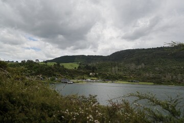 New Zealand Taupo Geothermal Park Cloudy Sky Above Lakeside Green