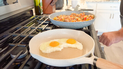 Gas stovetop with skillet of eggs and vegetables