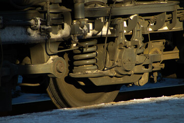 Wheels and Complex Coil Spring Suspension on a Blue Railway Freight Car Bogie
