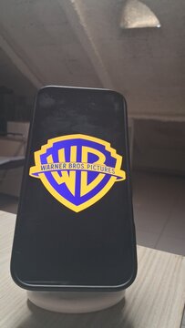 Smartphone Displaying Warner Bros Logo