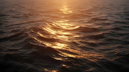 Golden hour sunlight reflects on dark ocean waves creating a serene and atmospheric seascape