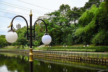 Garden lights for outdoor beauty and illumination. City gardens with circular garden lights. Illuminated garden lakes.
