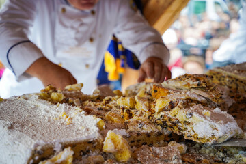 German Christmas Stollen close-up, traditional sweet bread with sugar powder. Famous European local food, travel