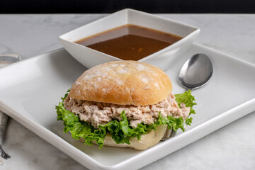  a bowl of french onion soup with atuna sandwich