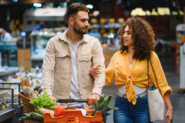 Couple shopping for groceries at supermarket