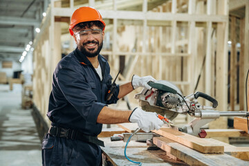 Friendly smile, positive mood. Portrait of a male carpenter posing in a woodworking workshop