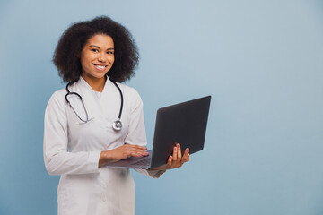 Young African American doctor using laptop for healthcare data