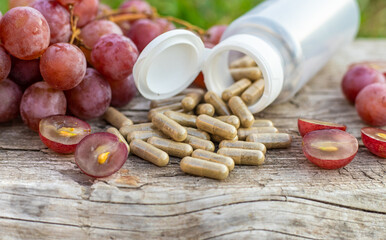 Grape seed extract in the garden. Selective focus.