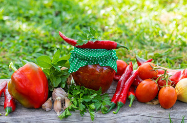 Adjika in a jar, canned. Selective focus.