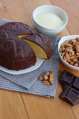 Sliced Italian traditional sweet cake called Parrozzo made with almonds and semolina on a plate on wooden table