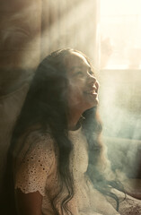 young woman looking out window