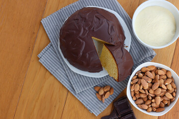 Sliced Italian traditional sweet cake called Parrozzo made with almonds and semolina on a plate on wooden table