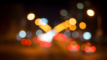 A blurred nighttime cityscape with vibrant colorful lights