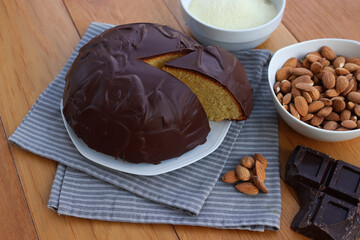 Sliced Italian traditional sweet cake called Parrozzo made with almonds and semolina on a plate on wooden table