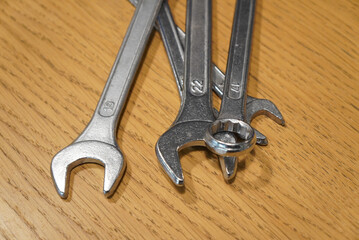 Close-up of wrenches on a wooden surface, ready for mechanical work