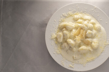 Pillowy gnocchi in creamy spinach sauce, tender potato dumplings bathed in cheesy white sauce with grated parmesan, warm rustic