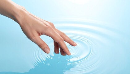 A delicate hand gently touches the surface of water, creating concentric ripples in a calming, blue setting