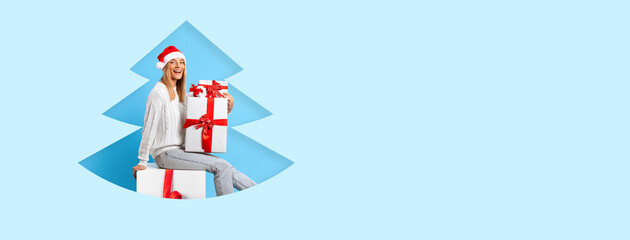 A cheerful woman wearing a red Santa hat sits among large wrapped gifts against a light blue background, celebrating the holiday season with joy and excitement.