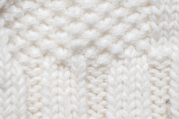 Close-up of a soft, textured white knit fabric, perfect for backgrounds