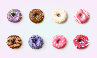 Eight different donuts are arranged in a grid on a light, simple background. Each donut features unique toppings and colors, ready to be enjoyed at a gathering or for dessert.