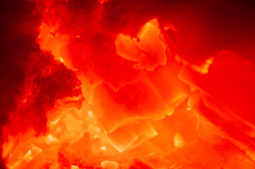 Abstract macro shot of glowing red hot embers and burning coals
