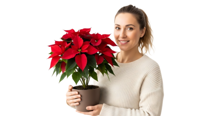 A woman holding a vibrant red poinsettia plant, smiling, adding a touch of festive cheer 