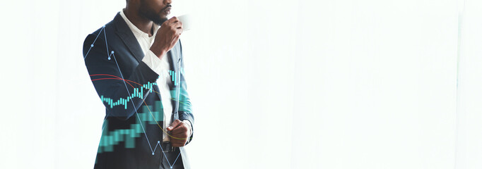 A pensive African American businessman stands by a window, sipping coffee and gazing at the city skyline. The scene captures a moment of contemplation in a modern office environment.