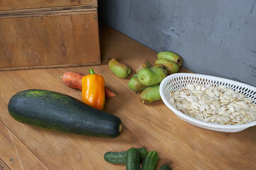 Autumn harvest, vegetables and fruits lie on a wooden table.