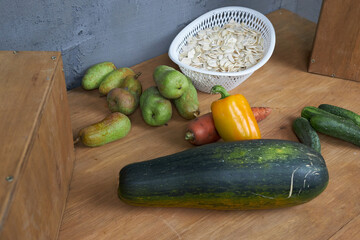 Autumn harvest, vegetables and fruits lie on a wooden table.