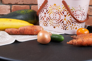 Autumn harvest, vegetables are lying near the basket.