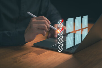 Person using a digital pen on a laptop to targets and review digital documents, illustrating workflow optimization, task completion, productivity planning, and data organization in a modern workspace.