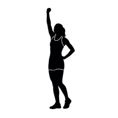 Silhouette of a woman in athletic wear raising her fist in victory.