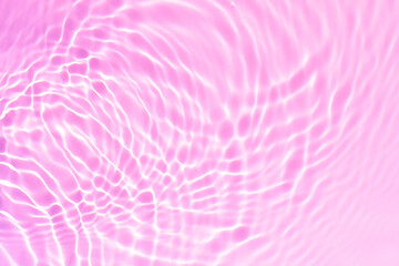 Pink water bubbles on the surface ripples. Defocus blurred transparent pink colored clear calm...