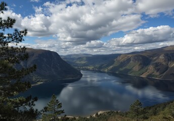 scenic view of a remote scottish loch nestled between rugged mountains under a dramatic cloudy sky.