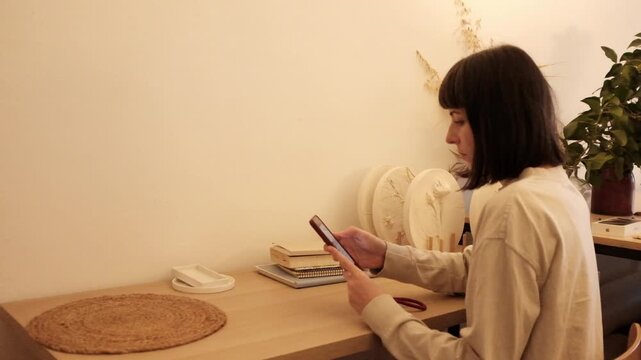 Closeup video of a young woman doom scrolling a smartphone. Addictive behaviour. Modern world problem. Social media marketing. Working through smartphone.