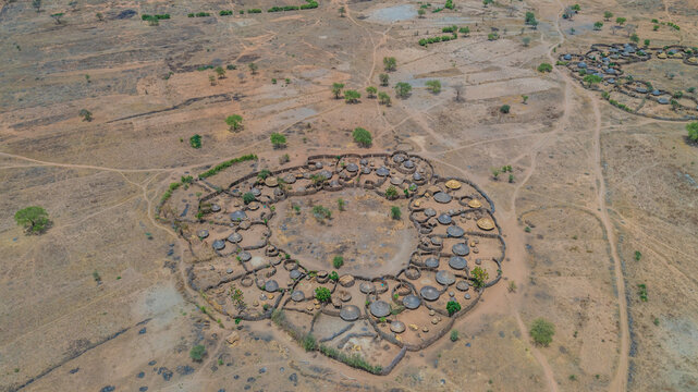 Aerial view of the traditional Manyatta villages, circular compounds etched into the arid landscape, a testament to resilience, Karamoja, Northern Region, Uganda.