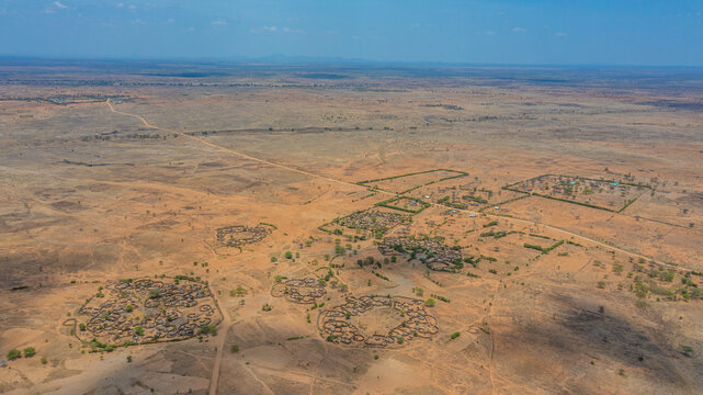 Aerial view of Manyatta villages standing as ancient fortresses amidst the arid landscape, a testament to resilience, Karamoja, Northern Region, Uganda.