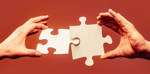 Two hands trying to connect couple puzzle. Business solutions, success and strategy concept