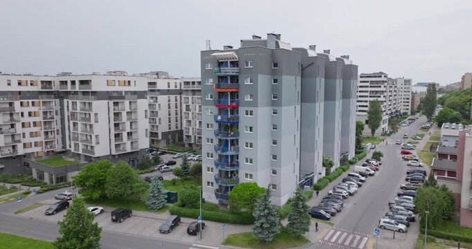 Renovated socialist-era residential building with contemporary facade, balconies and green surroundings. Typical example of urban renewal and housing transformation in Poland.