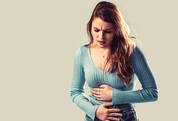 Woman suffering from abdominal pain. Painful disease feeling unwell. Ache concept. Stomach pain and...